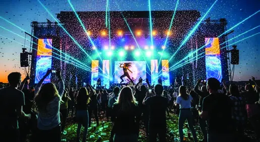 An open-air concert stage with lighting and sound systems installed