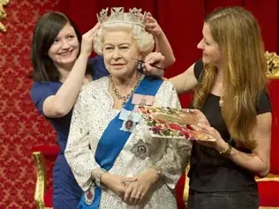 Visitors having their photo taken with a wax figure