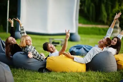 A group having fun on beanbags on the grass